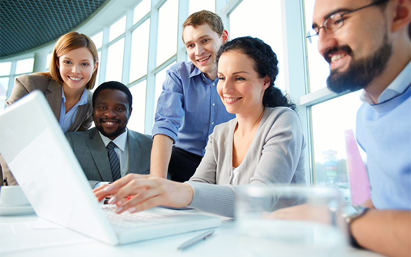 A team gathered round a laptop