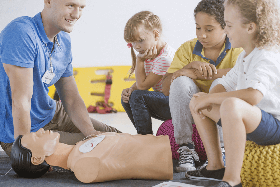 Primary school children learning first aid