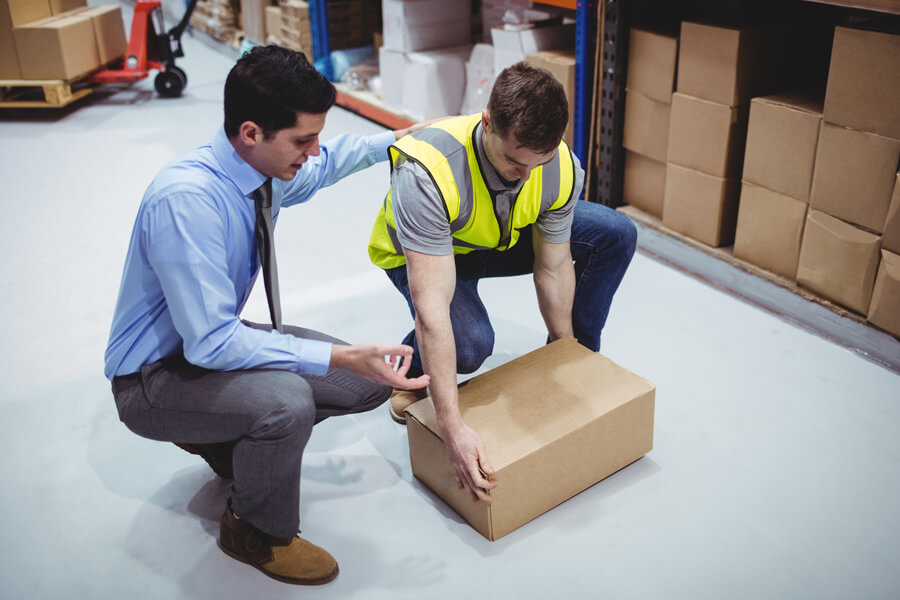 Man helping colleague lift and handle with care